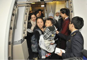 Chinese nationals evacuated from Libya, walk out of a chartered plane 