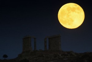 A supermoon rises over the temple of Poseidon in Cape Sounion, east of Athens
