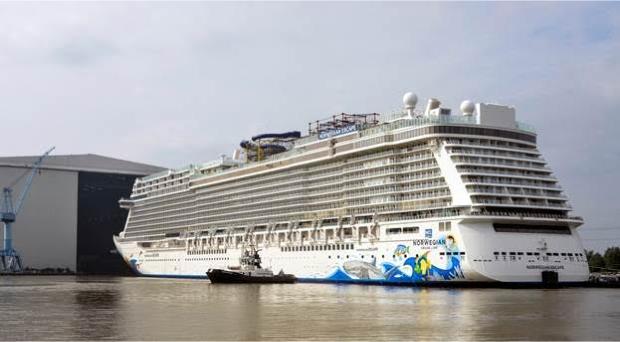 Norwegian Escape floats out from building dock