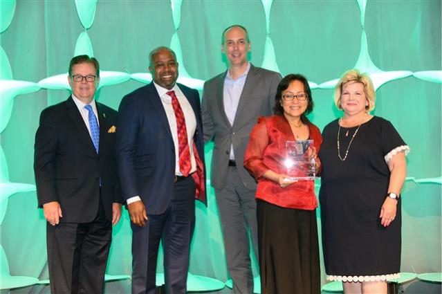 LAWA Chief Management Analyst Georginnah Navarrete (second from right) accepts the Best Airport Concessions Transformation award from ACI-NA.