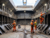 InnerHull expands cargo hold cleaning to 13 global markets Cargo hold cleaning crew in orange overalls pressure-washing and scrubbing a bulk carrier's cargo hold.