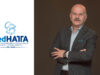 Ο πρόεδρος της FedHATTA, Λύσανδρος Τσιλίδης, με σταυρωμένα χέρια, δίπλα στο λογότυπο της Ομοσπονδίας.