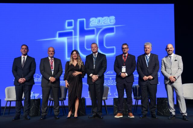 Panelists and moderator pose on stage in front of the ITC 2026 logo at the 9th Infrastructure and Transport Conference in Athens.